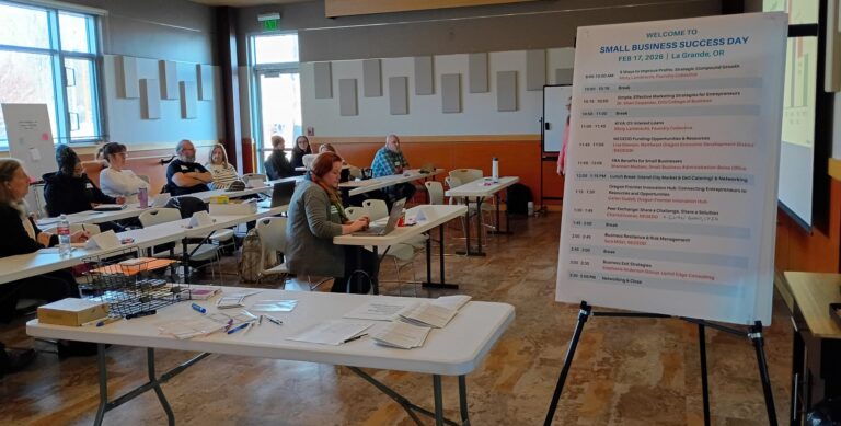 Shows the SBSD event in La Grande from the angle of the front registration desk looking at the audience